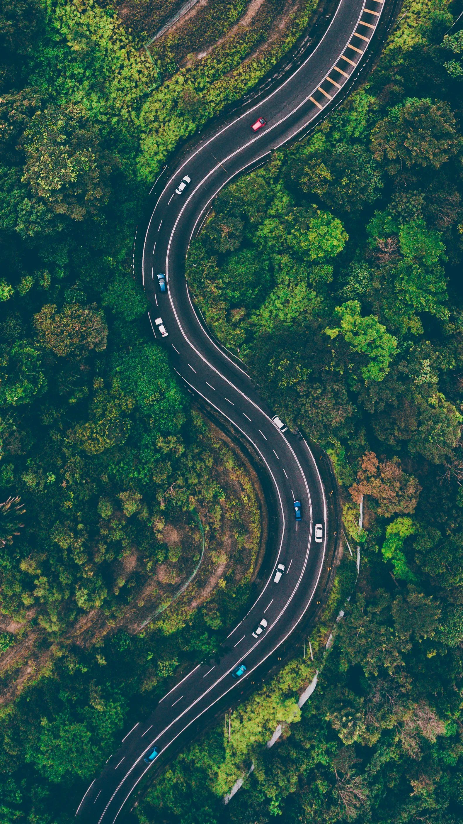 Map, compass, and camera laid out for a road trip